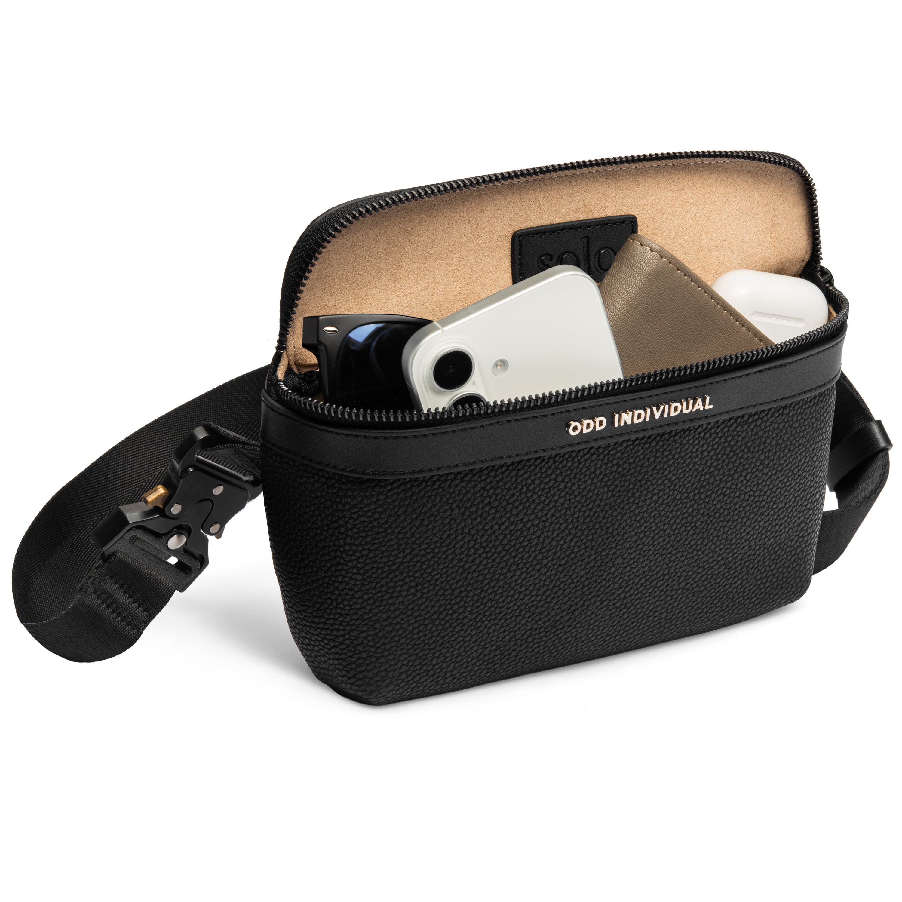 Men's sling bag with black pebble leather with a strap, containing electronic devices, sunglasses and wallet, on a white background.