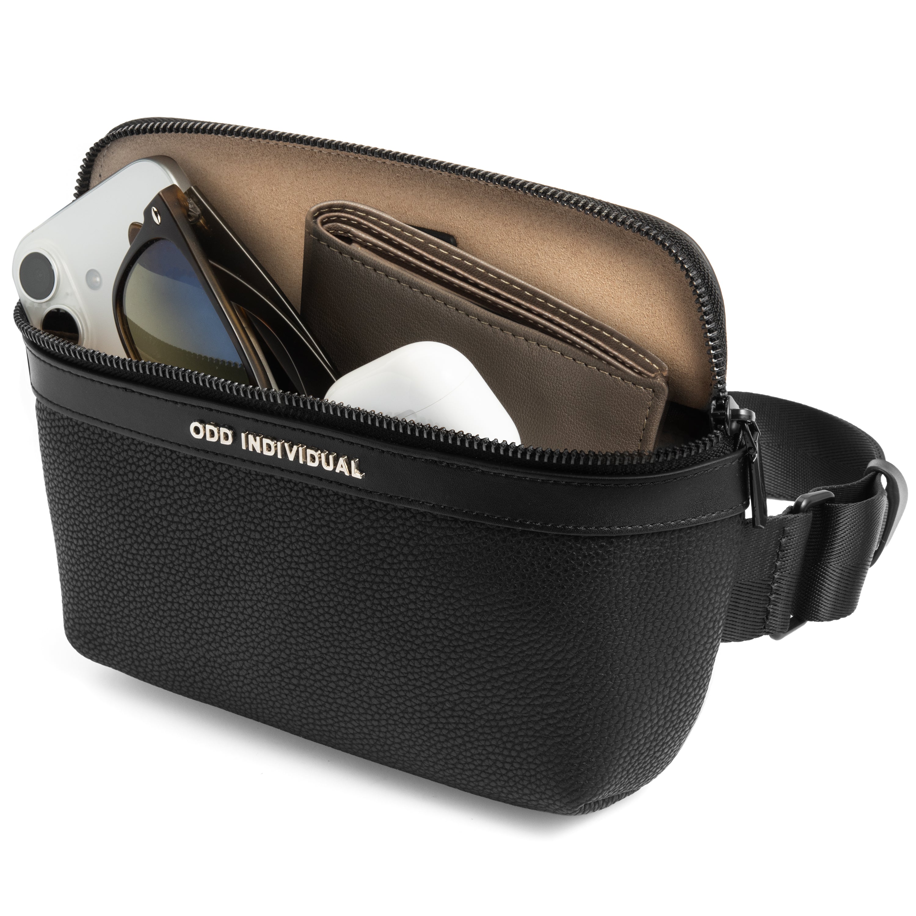 Men's sling bag with black pebble leather  with 'Odd Individual' branding, containing electronic devices, sunglasses, and a wallet on a white background.